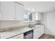 Updated kitchen featuring granite countertops, stainless steel appliances, and ample cabinet space at 4623 S Kalispell Way, Aurora, CO 80015
