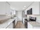 Updated kitchen featuring granite countertops, stainless steel appliances, and modern fixtures at 4623 S Kalispell Way, Aurora, CO 80015