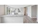 Bright, renovated kitchen with white cabinets, stone countertops, wood floors, and stainless appliances at 4623 S Kalispell Way, Aurora, CO 80015