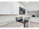 Updated kitchen with granite countertops and stainless steel appliances at 4623 S Kalispell Way, Aurora, CO 80015