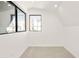 Bright bedroom with white walls, plush carpet, and windows with a view at 263 S Jackson St, Denver, CO 80209