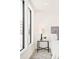 Bright bedroom features large windows, bedside table with lamp, and a comfortable bed with gray headboard at 263 S Jackson St, Denver, CO 80209