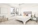 Spacious bedroom featuring large windows, ceiling fan, accent chair, and a comfortable bed with decorative pillows at 263 S Jackson St, Denver, CO 80209