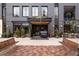 Stylish entrance with brick facade, 'Clayton' signage, benches and manicured greenery at 263 S Jackson St, Denver, CO 80209