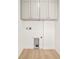 Functional laundry room with overhead cabinets, hookups for appliances, and ample storage space at 263 S Jackson St, Denver, CO 80209