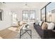 Cozy living room features a modern sofa, decor, and a large sunny window at 263 S Jackson St, Denver, CO 80209