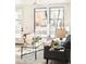 Cozy living room features a modern sofa, decor, and a large sunny window at 263 S Jackson St, Denver, CO 80209