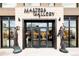 Grand entrance to Masters Gallery featuring elegant statues and a contemporary glass door facade at 263 S Jackson St, Denver, CO 80209
