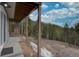 Expansive backyard featuring views of mountains and forests, with natural wooden beams and snowy spots at 31932 Steven Way, Conifer, CO 80433