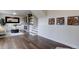 Finished basement featuring dark wood floors, modern decor, a fireplace, and stylish accents at 31932 Steven Way, Conifer, CO 80433