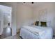 Well lit bedroom with a bed, a small window, and a view into another room at 31932 Steven Way, Conifer, CO 80433