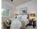 Cozy bedroom with vaulted ceiling and forest views from window that provide great natural light at 31932 Steven Way, Conifer, CO 80433