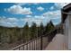 Expansive deck showcasing stunning wooded views and a serene outdoor living space at 31932 Steven Way, Conifer, CO 80433