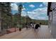 Spacious deck with mountain views, seating area, and outdoor living space at 31932 Steven Way, Conifer, CO 80433