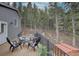 Spacious deck offering comfortable seating, hot tub access, and scenic forest views at 31932 Steven Way, Conifer, CO 80433