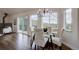 Bright dining room features hardwood floors, a view of the mountains, and glass table with upholstered chairs at 31932 Steven Way, Conifer, CO 80433
