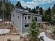 Gray two-story home featuring a modern design and complemented by the surrounding trees at 31932 Steven Way, Conifer, CO 80433