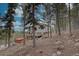 Beautiful exterior of a cabin-style home in a wooded area with a deck and a hot tub at 31932 Steven Way, Conifer, CO 80433
