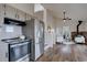 Bright kitchen with stainless steel appliances, white cabinetry, and hardwood floors at 31932 Steven Way, Conifer, CO 80433