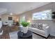 Bright living room with a large window, comfortable seating, and stylish decor, creating a welcoming atmosphere at 31932 Steven Way, Conifer, CO 80433