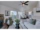 Bright living room flows into dining area, showcasing stylish decor and natural light from large windows at 31932 Steven Way, Conifer, CO 80433