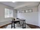 Bright office space with large window, a wooden desk, and minimalist botanical prints at 31932 Steven Way, Conifer, CO 80433