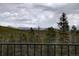Balcony view features serene mountain scenery and lush forest, enhancing the property's natural setting at 31932 Steven Way, Conifer, CO 80433