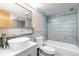 Updated bathroom featuring a vessel sink, modern fixtures, blue tile, and a shower-tub combination at 1121 Albion St # 305, Denver, CO 80220
