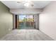 Cozy bedroom with neutral carpet, ceiling fan, and sliding glass door to the outdoor patio at 1121 Albion St # 305, Denver, CO 80220