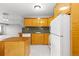 The kitchen features light wood cabinets, updated appliances, and a functional layout at 1121 Albion St # 305, Denver, CO 80220