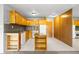 Functional kitchen with wood cabinets, backsplash, neutral flooring and modern appliances at 1121 Albion St # 305, Denver, CO 80220