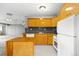 The kitchen features light wood cabinets, updated appliances, and a functional layout at 1121 Albion St # 305, Denver, CO 80220