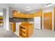 Functional kitchen with wood cabinets, backsplash, neutral flooring and modern appliances at 1121 Albion St # 305, Denver, CO 80220