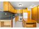 Well-lit kitchen featuring light cabinets, gray backsplash and modern appliances at 1121 Albion St # 305, Denver, CO 80220
