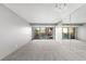Large living area with private balcony access, neutral tones, and a wall of mirrors at 1121 Albion St # 305, Denver, CO 80220