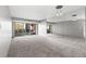 A living room featuring light walls, soft carpet, and access to the balcony at 1121 Albion St # 305, Denver, CO 80220
