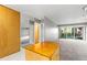 Bright living space featuring a large window, neutral tones, and adjacent kitchen area at 1121 Albion St # 305, Denver, CO 80220