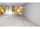 Bright living room featuring neutral carpet, mirrored wall, and an adjoining kitchen at 1121 Albion St # 305, Denver, CO 80220