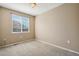 Bright bedroom featuring neutral walls, carpet, and a large window with blinds for natural light at 16149 E Geddes Ln # 99, Aurora, CO 80016