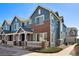 Stylish townhouse exterior with blue siding, brick accents, and well-manicured front yard at 16149 E Geddes Ln # 99, Aurora, CO 80016