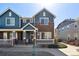 Charming two-story townhome with a brick facade and a cozy front porch at 16149 E Geddes Ln # 99, Aurora, CO 80016