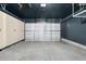 Spacious garage with ample storage cabinets, overhead lighting, and a clean, finished floor at 16149 E Geddes Ln # 99, Aurora, CO 80016