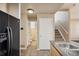 Bright kitchen featuring tile floors, stainless steel sink, and a black refrigerator, offering a functional cooking space at 16149 E Geddes Ln # 99, Aurora, CO 80016