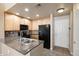 Well-appointed kitchen featuring granite countertops and black appliances at 16149 E Geddes Ln # 99, Aurora, CO 80016