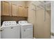 Functional laundry room with cabinets, wire shelving, and modern washer and dryer for convenience at 16149 E Geddes Ln # 99, Aurora, CO 80016