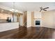 Open-concept living room showcasing a fireplace and seamless flow into the kitchen at 16149 E Geddes Ln # 99, Aurora, CO 80016