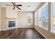 Sunlit living room featuring a cozy fireplace and views of the surrounding neighborhood at 16149 E Geddes Ln # 99, Aurora, CO 80016