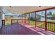 Covered back porch with red painted wood and a view of the backyard at 1716 Fulton St, Aurora, CO 80010
