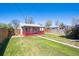 House exterior and backyard with green grass and a walkway at 1716 Fulton St, Aurora, CO 80010