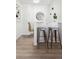 Stylish bar area features modern stools, updated flooring and ample space for entertaining at 1716 Fulton St, Aurora, CO 80010